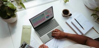 An employee looks over business data on her laptop