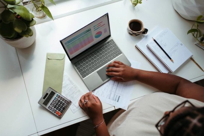 An employee looks over business data on her laptop